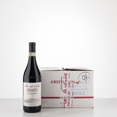 the bottle of wine is next to a box of wine