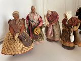 five figurines of women dressed in traditional clothing