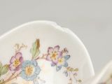 a small white bowl with a floral design on it
