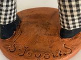 a figurine of a man standing on top of a base