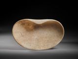 an old stone heart shaped object sitting on top of a table