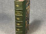 a close up of a green book on a gray surface