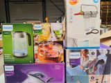 several boxes of household items are stacked on a table in a warehouse