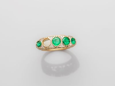 an emerald and diamond three stone ring