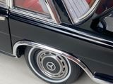 a close up of a black car with chrome rims