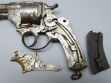 a gun that is sitting on a table next to a piece of wood