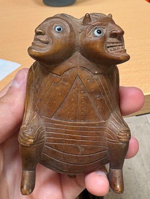 a person holding a small statue of a turtle