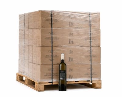a bottle of wine sitting on a pallet next to a stack of boxes