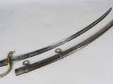 a pair of two swords, one of which has been cut in half