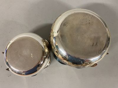 pair of silverplated sugar and butter dishes on a table
