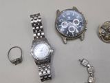 a silver watch and a silver bracelet on a table