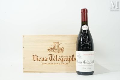 a bottle of wine sitting next to a wooden box