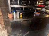 stainless steel counter top in a commercial kitchen with lots of condiments on it