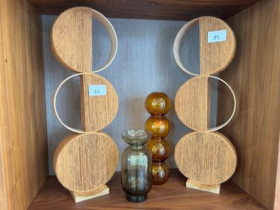 a wooden shelf with a glass vase on top of it