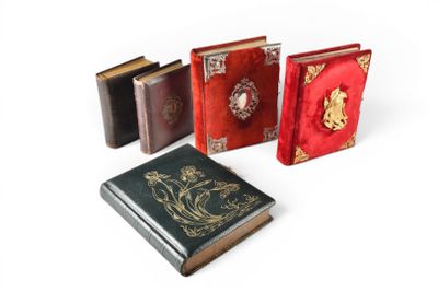 several books are lined up in a row on a white surface