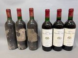 six bottles of wine are lined up in a row on a table