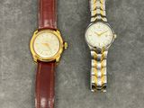 two watches sitting next to each other on a table