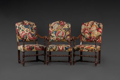 a set of three carved and upholstered armchairs