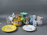 many different types of vases and plates on the table