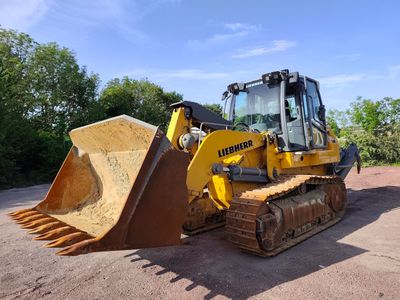 a yellow bulldozer that is parked in the dirt