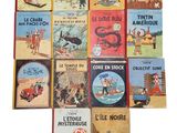 several children ' s books sitting on top of each other on a white surface