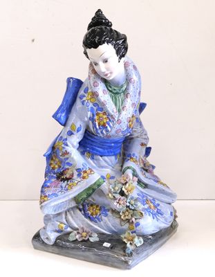 une figurine représentant une femme assise sur une table