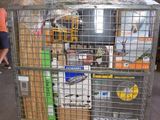 a metal cart with many items in it in a warehouse