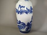 a blue and white vase sitting on a table