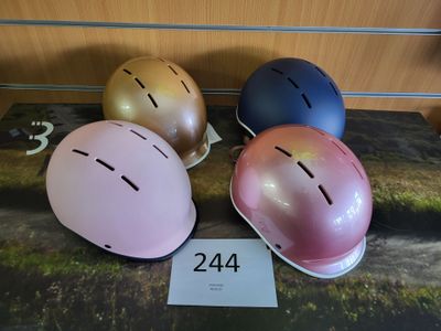 Plusieurs casques sont alignés sur une table, accompagnés d'une étiquette de prix