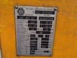 a sign on the side of a yellow machine