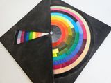 a close up of a piece of paper with a colorful circle on it