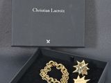 a black box with a pair of gold star earrings in it