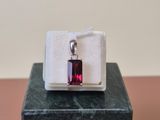 sterling silver and garnetite pendant on a marble block