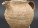 a small vase that is sitting on a glass stand