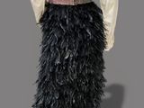 an image of a mannequin wearing a black feather skirt