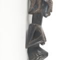 an image of a wooden sculpture of a man with a hat on his head