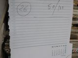a pile of papers and a piece of paper with writing on it