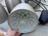 a person holding a lamp that is on a table