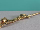 a close up of a tiger head on a stick on a table