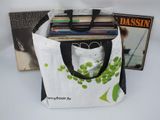 a tote bag with a bunch of records in it