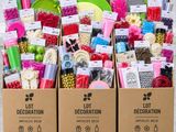 a box filled with lots of craft supplies sitting on top of a wooden pallet
