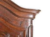 a close up of a wooden headboard on a bed