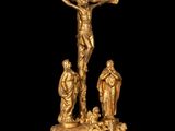 an image of a gold statue of jesus on the cross