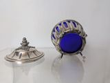 a small blue object sitting on top of a glass table