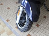 a close up of a motorcycle tire on a tiled floor