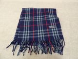 a close up of a blue and red plaid scarf on a white surface