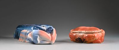 two small figurines sitting next to each other on a table