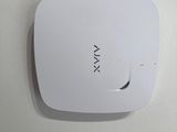 a white wall mounted device on the wall in the bathroom