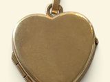 a gold heart shaped locke with a chain around it