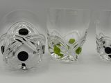 three glasses with black and white designs on them